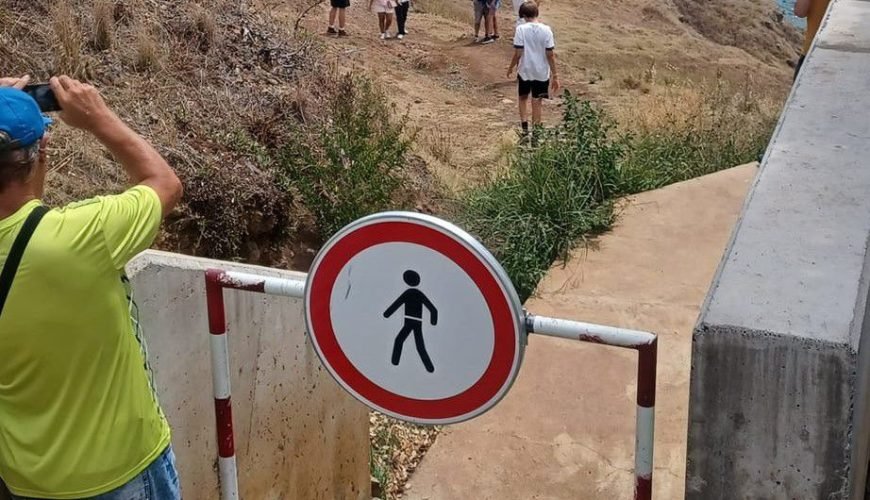 Tourists jump barrier to take pictures in Faial